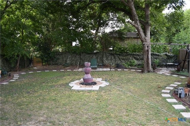 view of grassy yard with a fire pit