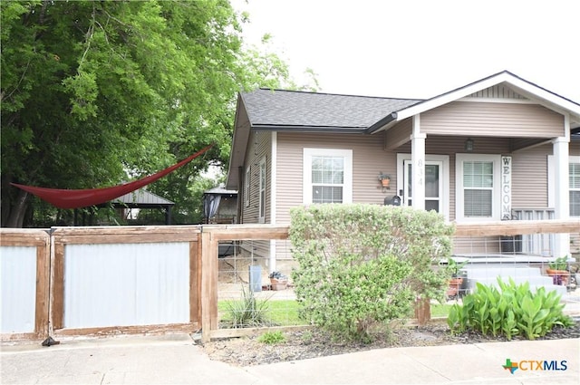 bungalow with roof with shingles and fence