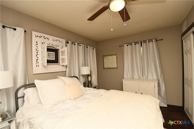 bedroom with dark wood finished floors and a ceiling fan