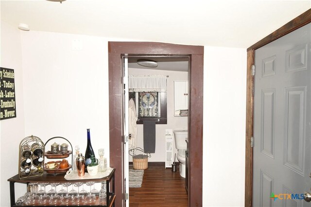 hall featuring wood finished floors and baseboards