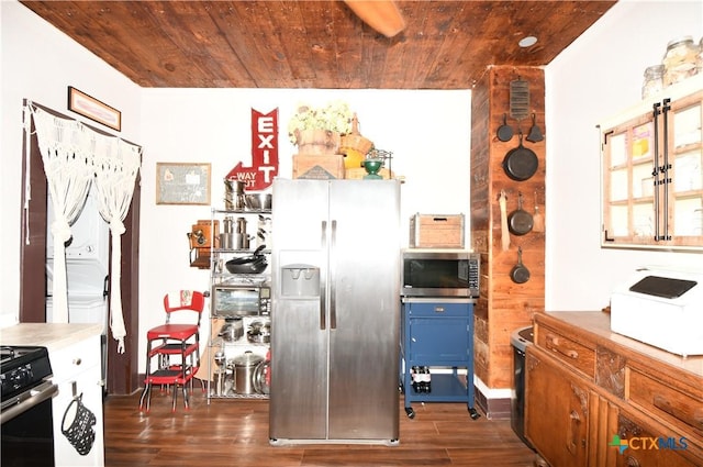 kitchen featuring appliances with stainless steel finishes, wooden ceiling, dark wood-type flooring, blue cabinetry, and light countertops