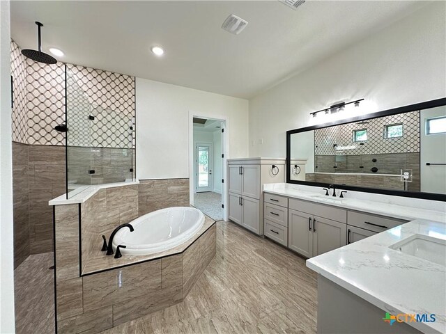 425 Dos Rios Dr, Belton, TX 76513 - full bath featuring two vanities, a walk in shower, a bath, and a wainscoted wall