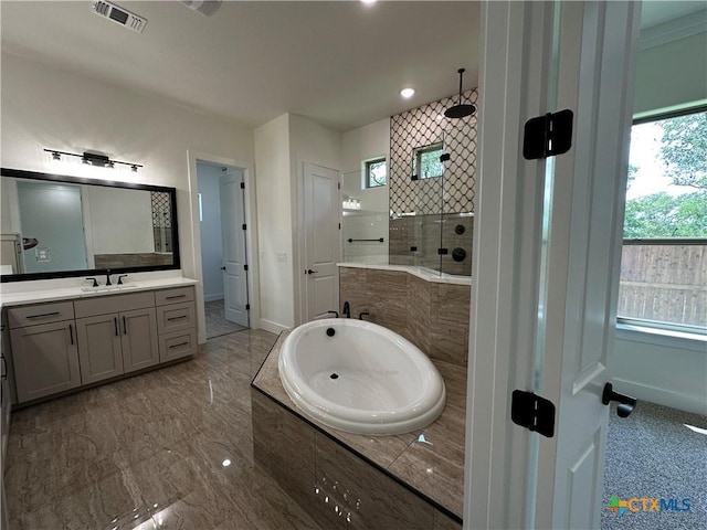 425 Dos Rios Dr, Belton, TX 76513 - bathroom featuring tiled shower, vanity, a garden tub, marble finish floors, and baseboards