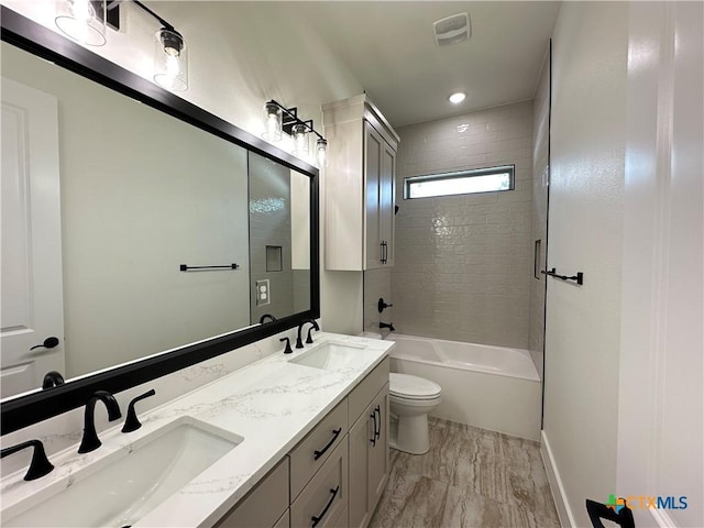 425 Dos Rios Dr, Belton, TX 76513 - bathroom featuring double vanity, toilet, and shower / bathtub combination
