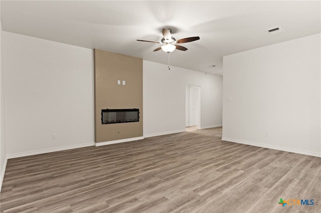 5113 Rose Petal Ct, Killeen, TX 76542 - unfurnished living room featuring a ceiling fan, wood finished floors, and baseboards