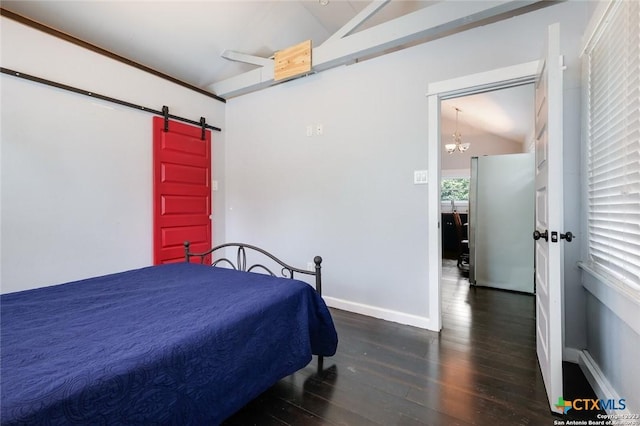 bedroom featuring stainless steel fridge, dark wood-type flooring, a barn door, a chandelier, and lofted ceiling