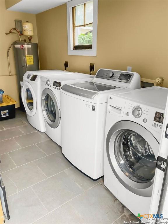 laundry room with light tile patterned floors and washer and clothes dryer