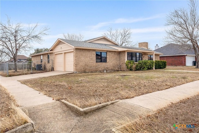 single story home with a garage and a front yard