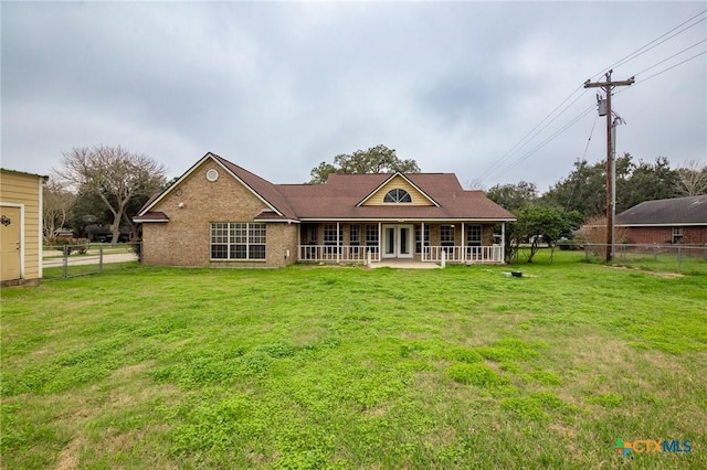 rear view of property with a lawn