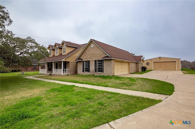 view of front of house featuring a porch, a garage, and a front lawn