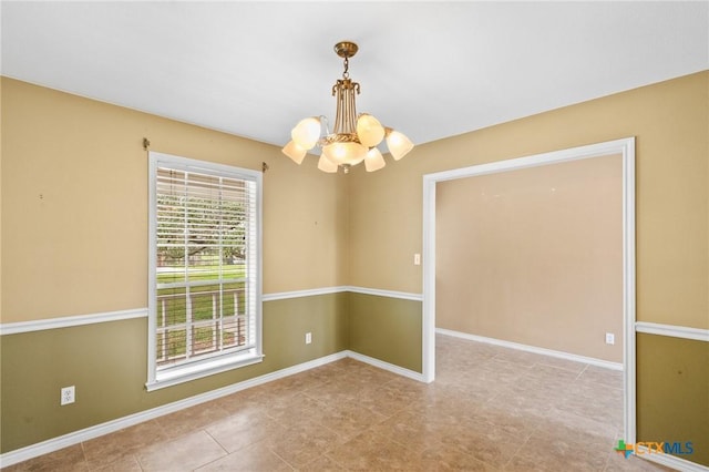 spare room with light tile patterned floors and a chandelier