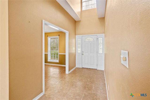 tiled foyer entrance featuring a high ceiling