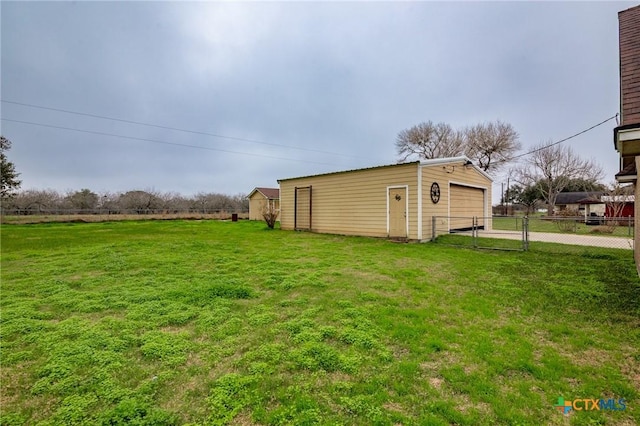 view of yard with a garage and an outdoor structure