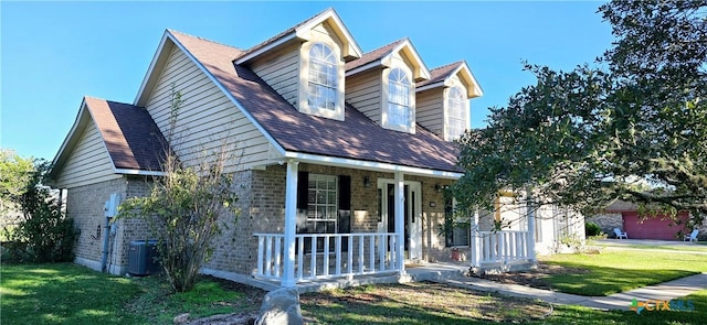 view of front of house with covered porch, central air condition unit, and a front yard