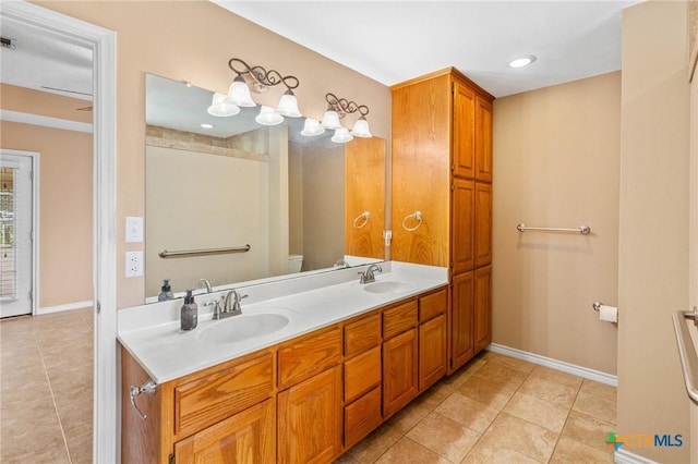 bathroom with vanity, tile patterned flooring, and toilet