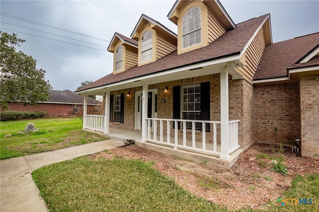 view of front of home with covered porch and a front yard