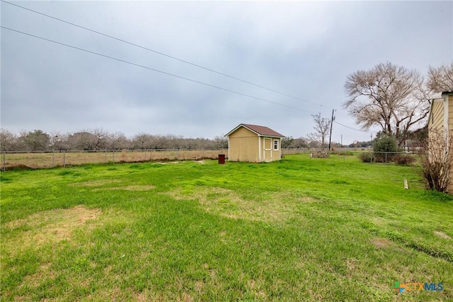 view of yard with a rural view and a shed