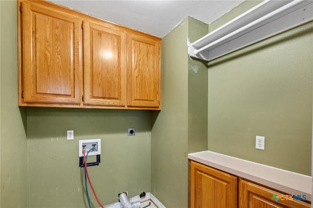 clothes washing area featuring electric dryer hookup, washer hookup, and cabinets