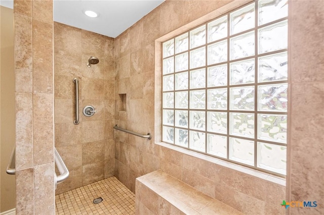 bathroom with a tile shower