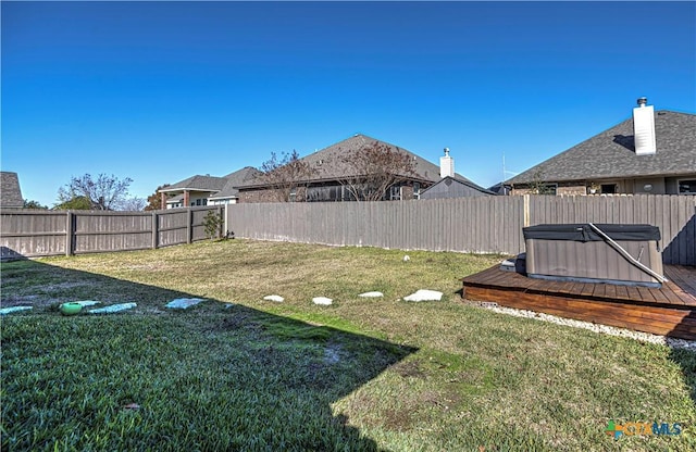 view of yard featuring a wooden deck and a hot tub