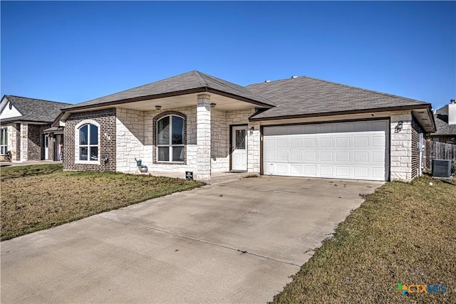 ranch-style home with central AC unit, a front yard, and a garage