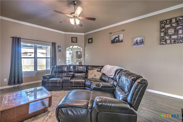 living room featuring ceiling fan, wood-type flooring, and ornamental molding