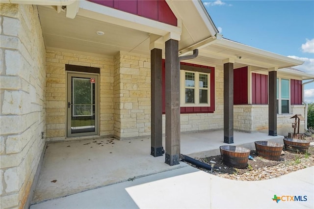 4049 Hickory Forrest Dr, Seguin, TX 78155 - view of exterior entry with board and batten siding, stone siding, and covered porch