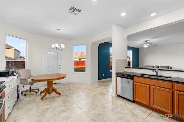 kitchen with sink, tasteful backsplash, ceiling fan with notable chandelier, decorative light fixtures, and stainless steel dishwasher