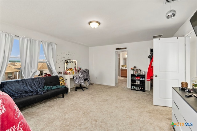 sitting room featuring light colored carpet