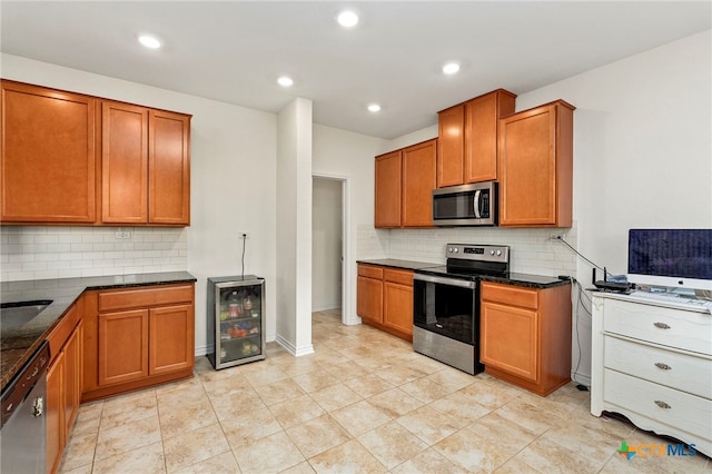 kitchen with light tile patterned floors, wine cooler, backsplash, and appliances with stainless steel finishes