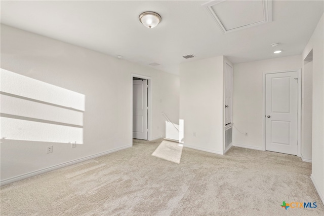 spare room featuring light colored carpet