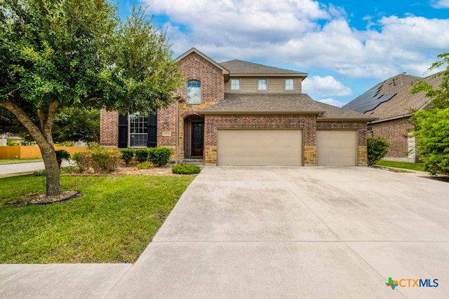 view of property featuring a front yard and a garage