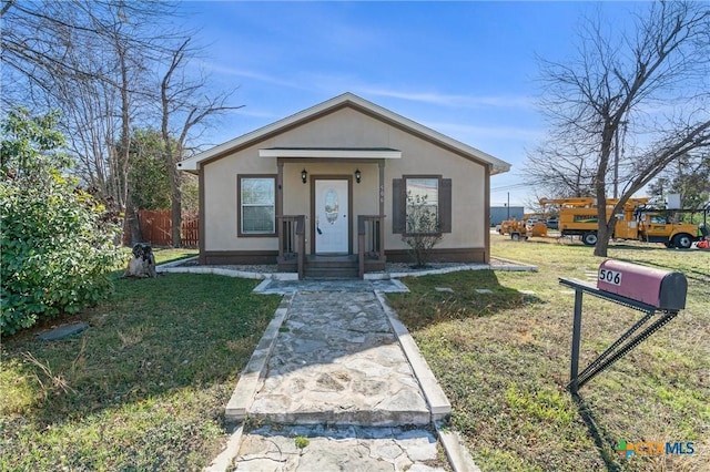 bungalow-style home with a front yard