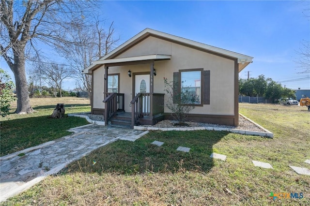 bungalow-style house featuring a front lawn