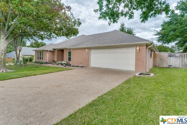 ranch-style home featuring a garage and a front lawn