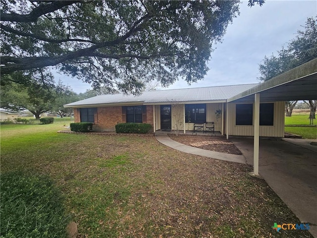 view of front of house with a front yard and a carport