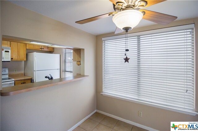 kitchen with white appliances, ceiling fan, sink, and light tile patterned floors