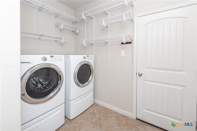 253 Flushing, New Braunfels, TX 78130 - clothes washing area with washing machine and dryer, laundry area, baseboards, and light tile patterned flooring