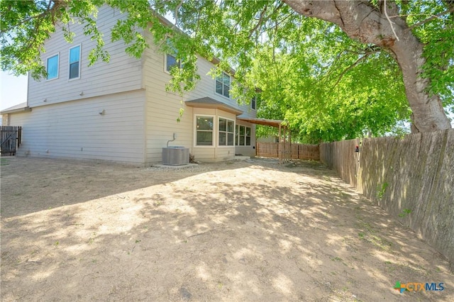 253 Flushing, New Braunfels, TX 78130 - rear view of house featuring central AC and a fenced backyard