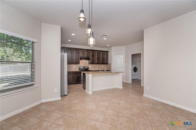253 Flushing, New Braunfels, TX 78130 - kitchen with washer / clothes dryer, dark brown cabinetry, light tile patterned flooring, visible vents, and stainless steel appliances