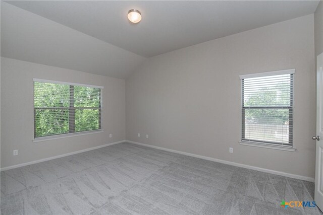 253 Flushing, New Braunfels, TX 78130 - spare room with baseboards, carpet, and lofted ceiling