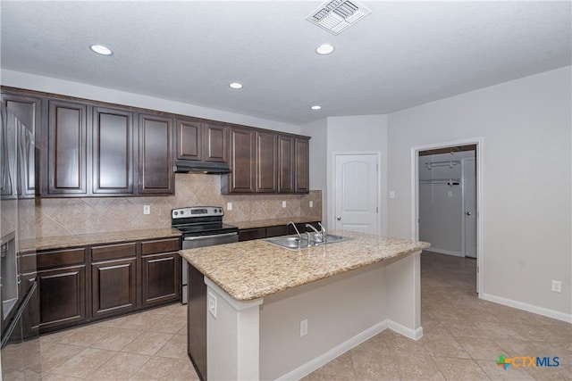 253 Flushing, New Braunfels, TX 78130 - kitchen featuring tasteful backsplash, visible vents, under cabinet range hood, light tile patterned flooring, and a sink