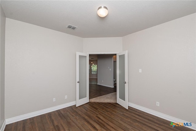253 Flushing, New Braunfels, TX 78130 - spare room with baseboards, dark wood finished floors, and visible vents