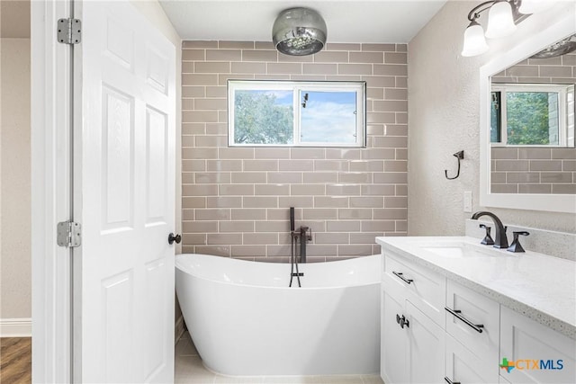 111 Warwick Glen St, Victoria, TX 77904 - bathroom featuring vanity, a soaking tub, and plenty of natural light