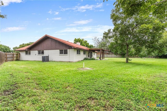 111 Warwick Glen St, Victoria, TX 77904 - rear view of property featuring a fenced backyard, brick siding, and a chimney
