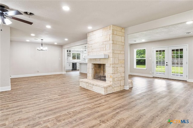 111 Warwick Glen St, Victoria, TX 77904 - unfurnished living room featuring wine cooler, a ceiling fan, light wood-style floors, a chandelier, and recessed lighting