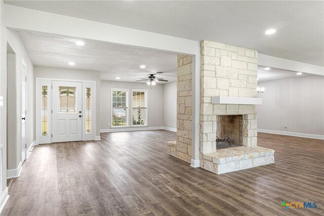 111 Warwick Glen St, Victoria, TX 77904 - unfurnished living room with ceiling fan, wood finished floors, a textured ceiling, recessed lighting, and a fireplace