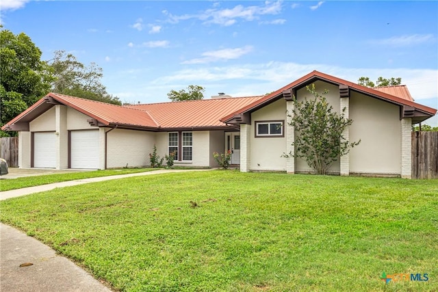 111 Warwick Glen St, Victoria, TX 77904 - view of front of home with a metal roof, an attached garage, and concrete driveway