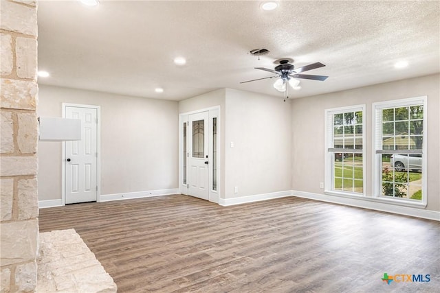 111 Warwick Glen St, Victoria, TX 77904 - unfurnished living room with wood finished floors, ceiling fan, recessed lighting, and a textured ceiling