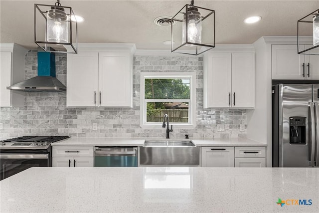 111 Warwick Glen St, Victoria, TX 77904 - kitchen with appliances with stainless steel finishes, wall chimney range hood, white cabinets, light stone countertops, and recessed lighting